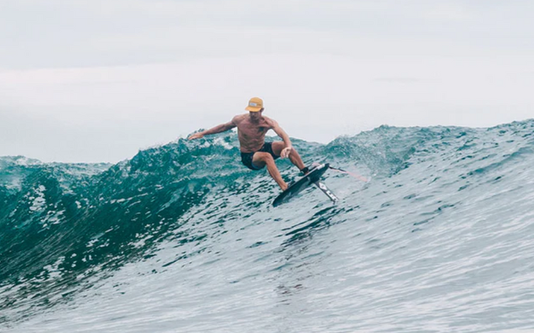 Green Hat Kiteboarding-Action Shot-Man Surf Foiling a Wave