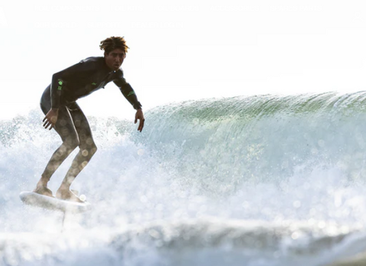 Green Hat Kiteboarding-2024 Cabrinha Bump Prone Foilboard-Man foil surfing on a wave in a wetsuit