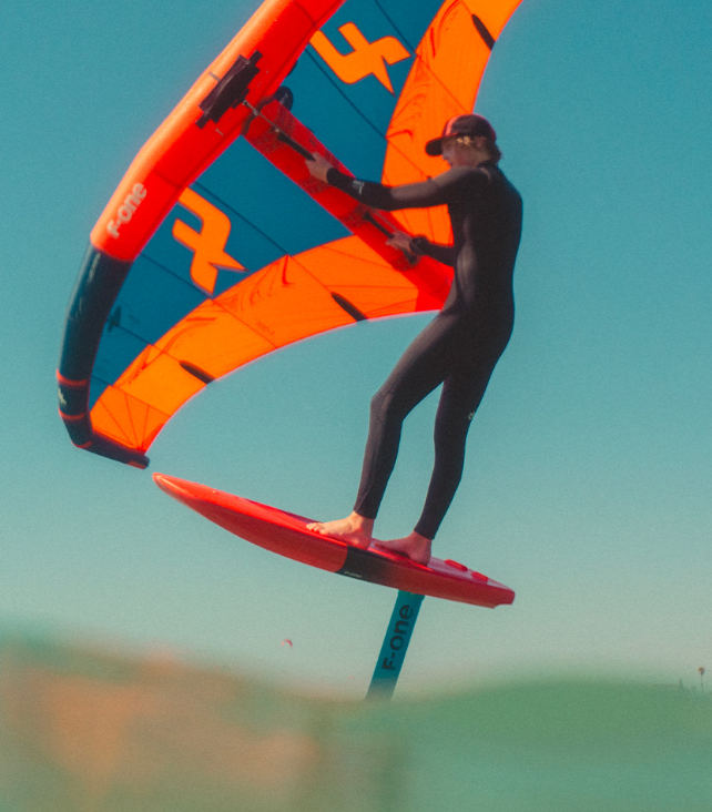 Load image into Gallery viewer, Green Hat Kiteboarding-F-One V4 Rocket Wing Board-Action Shot-Man Winging on F-One Gear