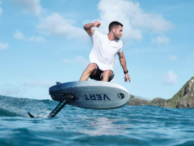 Load image into Gallery viewer, North Vert Prone Foil Board-Action Shot-Man prone Surfing a Foil on a Wave with a Scenic Background