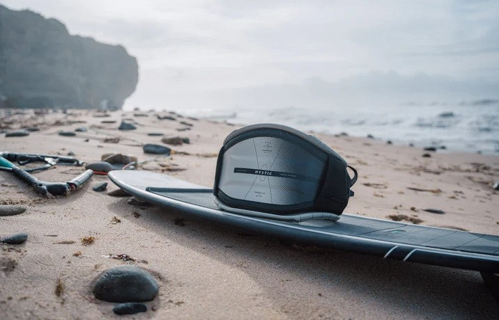 Load image into Gallery viewer, Green Hat Kiteboarding-2025 Mystic Women's Stealth Hardshell Kite Harness-Live Shot-Harness on North Surfboard on the Beach