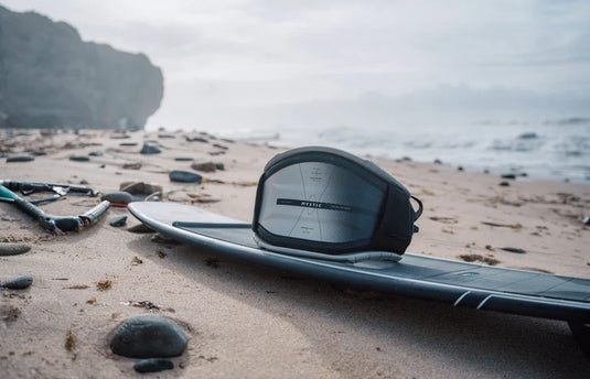 Green Hat Kiteboarding-2025 Mystic Women's Stealth Hardshell Kite Harness-Live Shot-Harness on North Surfboard on the Beach