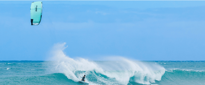 Load image into Gallery viewer, Green Hat Kiteboarding-2025_F-One_Addikt_Kite-Black/Mint-Pro Rider Keahi Surfing a Wave in Hawaii on the F-One Addikt Wave Kite