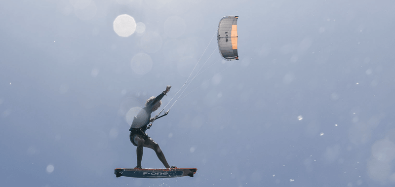 Load image into Gallery viewer, Green Hat Kiteboarding-2025_F-One_Bandit_TEC_Kite-Kiter Riding a 2025 F-One Bandit TEC Kiteboard Kite