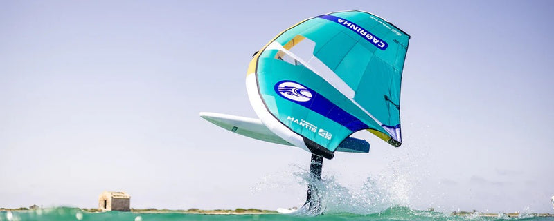 Load image into Gallery viewer, Green Hat Kiteboarding-2026 Cabrinha Mantis APEX-Action Shot-Man Breaching on Cabrinha Mantis APEX on Clear Blue Water