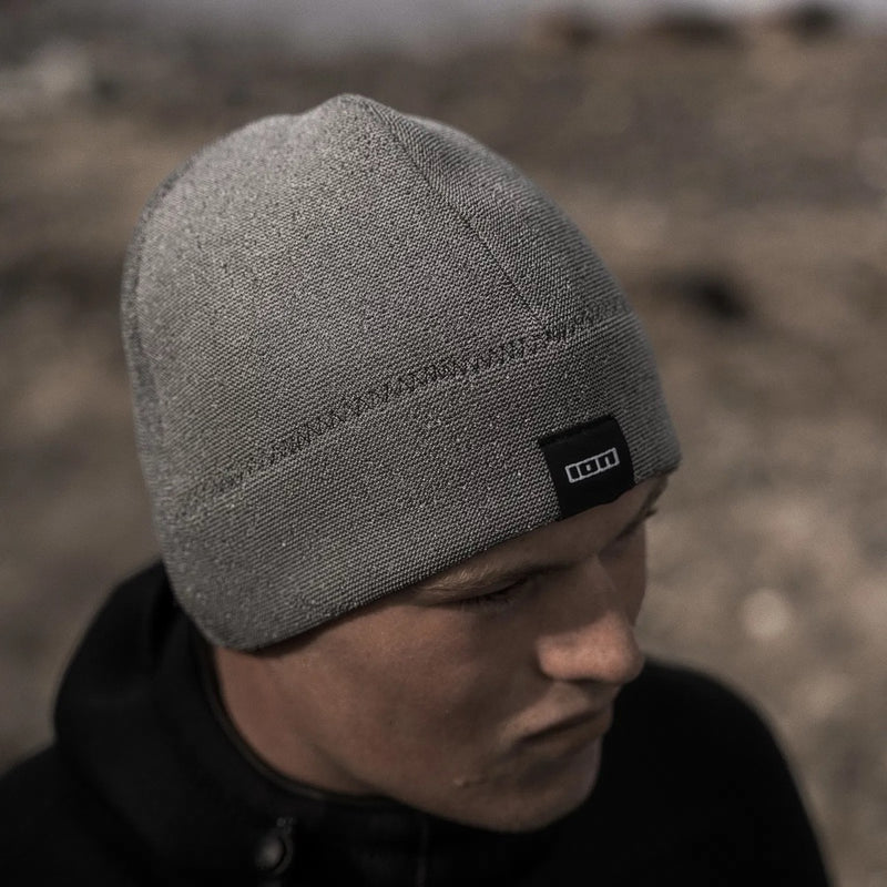 Load image into Gallery viewer, Person wearing a gray beanie with an Ion logo in a blurred natural setting