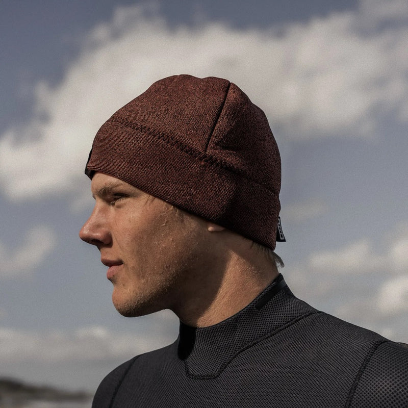 Load image into Gallery viewer, Person wearing an Ion Beanie against a cloudy sky