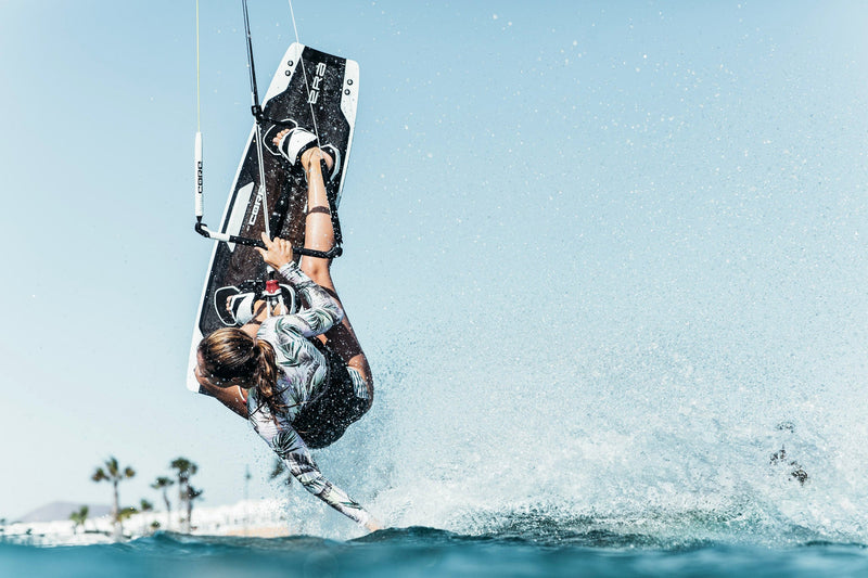 Load image into Gallery viewer, Green Hat Kiteboarding-Core ERA Twin Tip-Action Shot-Woman kiteboarding on Core ERA Twin Tip