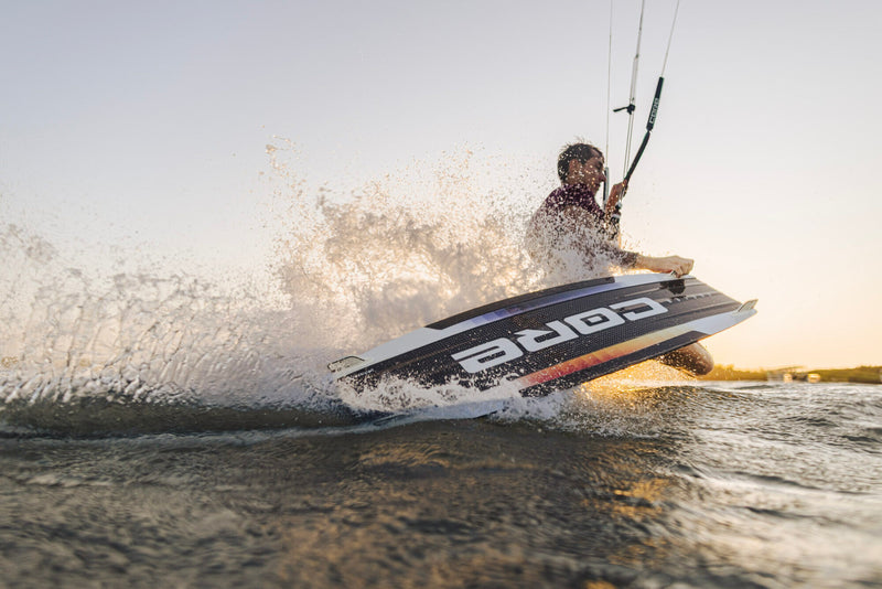 Load image into Gallery viewer, Green Hat Kiteboarding-Core Fusion 7 Kiteboard-Action Shot-Man Doing a Dark Slide While Kiteboarding a Core Fusion 7 Kiteboard