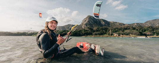 Green Hat Kiteboarding-2025 Cabrinha Nitro APEX Kite-Live Shot-Man Sitting in the Water Flying a Nitro APEX Kite
