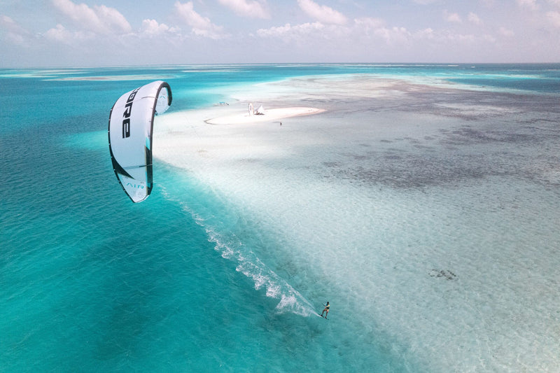 Load image into Gallery viewer, Green Hat Kiteboarding-Core AIR LW Kite-Action Shot-Man Riding a Core Air in the Air on Crystal Blue Water