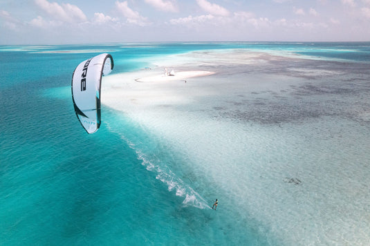 Green Hat Kiteboarding-Core AIR LW Kite-Action Shot-Man Riding a Core Air in the Air on Crystal Blue Water
