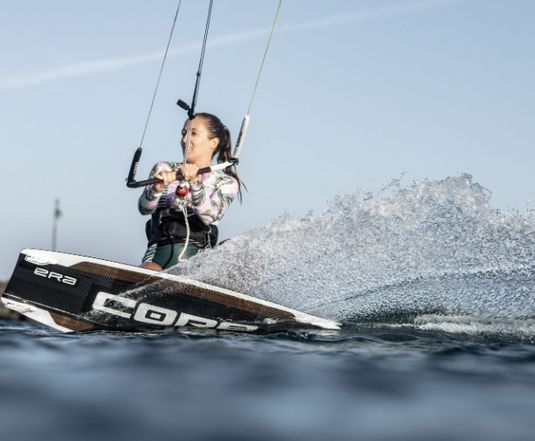 Green Hat Kiteboarding-2025 Core ERA LW Kiteboard-Action Shot-Woman Riding a Core ERA LW Board
