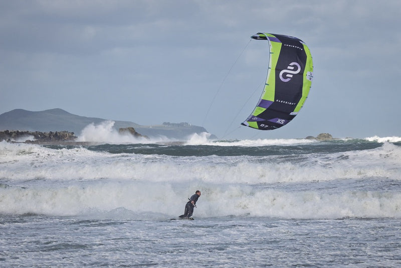 Load image into Gallery viewer, Green Hat Kitebording-2025 Eleveight XS V6 Kite-Action Shot-Man Wave Riding on the Eleveight XS V6 Kite