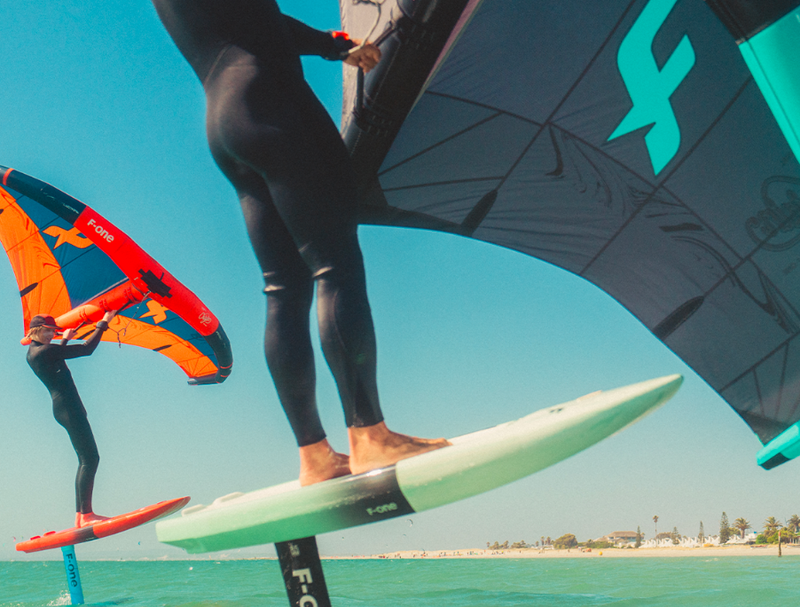 Load image into Gallery viewer, Green Hat Kiteboarding-F-One Origin V1 Wing-Action Shot-Close Up of 2 Men Winging on F-One Origin V1