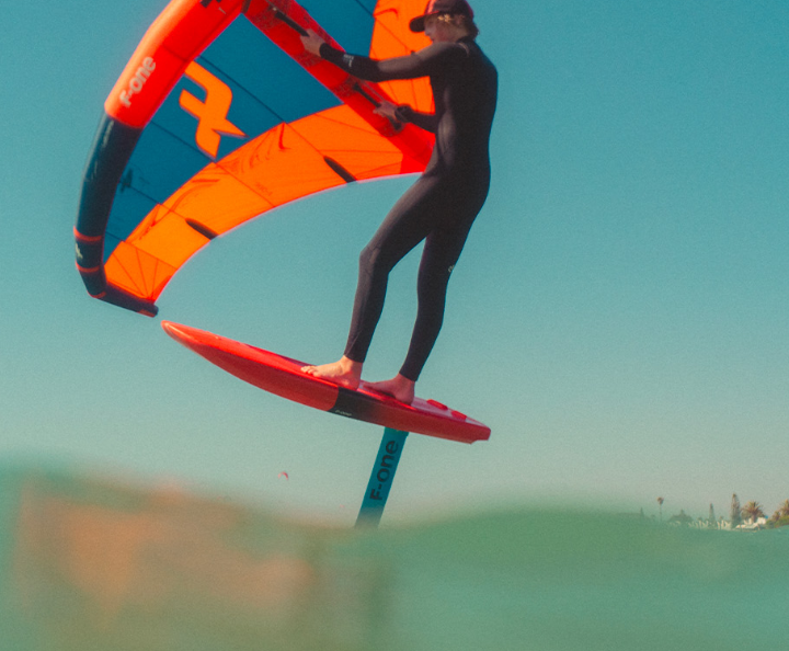 Load image into Gallery viewer, Green Hat Kiteboarding-F-One Phantom FCT Plane-Action Shot-Man Wing Foiling on an F-One Phantom