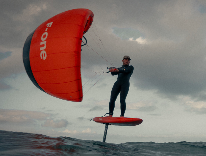 Load image into Gallery viewer, Green Hat Kiteboarding-F-One Plume-Live Shot-Man Riding an F-One Plume on an F-One Foilboard