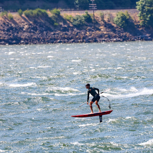 Green Hat Kiteboarding-Action Shot- Man Downwinding Using a Kaohi Leash