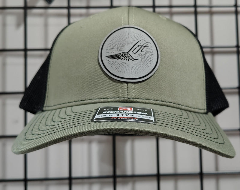 Load image into Gallery viewer, Green Hat Kiteboarding-Lift Foils Original Trucker Hat-Olive Green-Front View of cap on a grid background