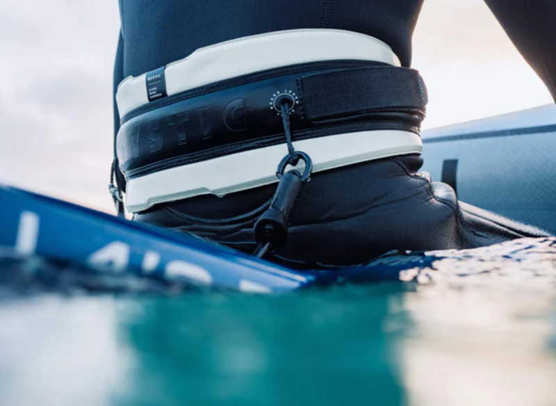 Load image into Gallery viewer, Green Hat Kiteboarding-Mystic Stage Wing Harness-Live Shot-Man Sitting on a Board in the Water Wearing Stage Harness