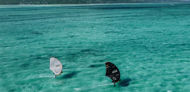 Load image into Gallery viewer, Green Hat Kiteboarding-Ozone Fusion V2 Ultra-X Wing-Action Shot-Two People Wing Foiling on a Black and a White Fusion V2 Wing