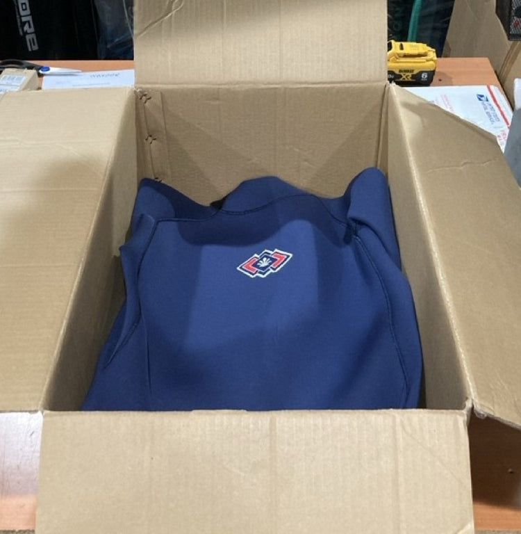 Green Hat Kiteboarding-Pages-Return/Refund Policy-Saint-Jacques Wetsuit in a Cardboard box