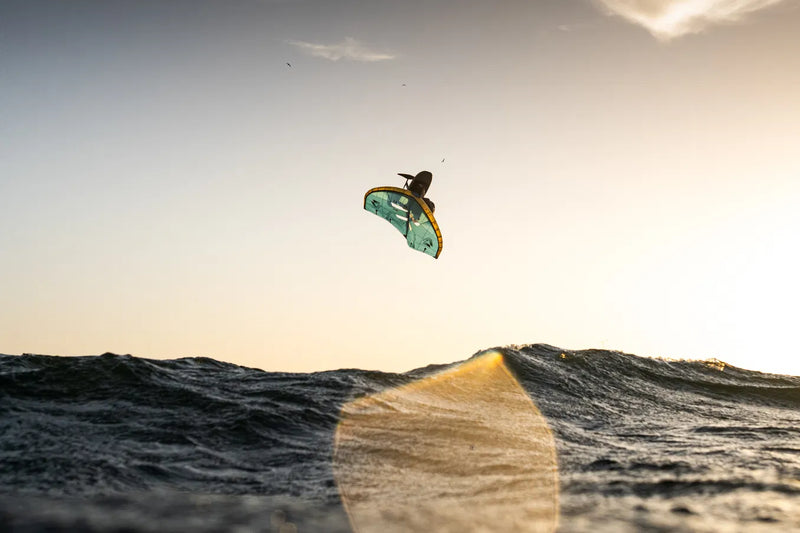 Load image into Gallery viewer, Green Hat Kiteboarding-2026 Duotone Unit D/Lab Wing-Action Shot-Person jumping a Wave on the 2026 Unit D/Lab