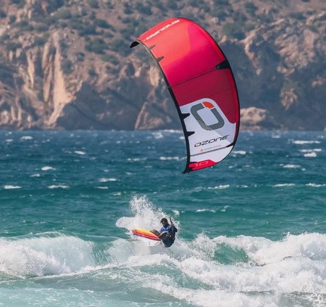 Load image into Gallery viewer, Green Hat Kiteboarding-Ozone Enduro V5 Kiteboarding Kite-10m RED-Action Shot-Kiter surfing a wave on Ozone Enduro Kite