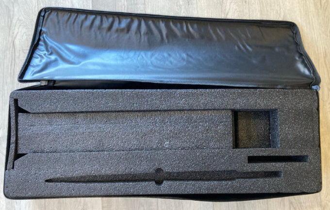 Load image into Gallery viewer, Green Hat Kiteboarding Takuma Mast Carrying Case USED-Open View on Wooden Surface
