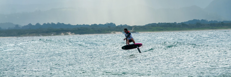 Green Hat Kiteboarding-Main Page Banner for Desktop-Man Foiling Swell on Unifoil Gear
