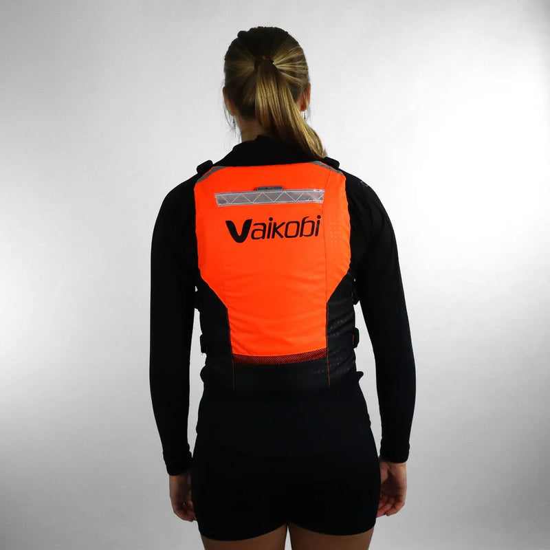 Load image into Gallery viewer, Green Hat Kiteboarding-Vaikobi PFD Orange-Woman wearing an orange and black life vest on a white background
