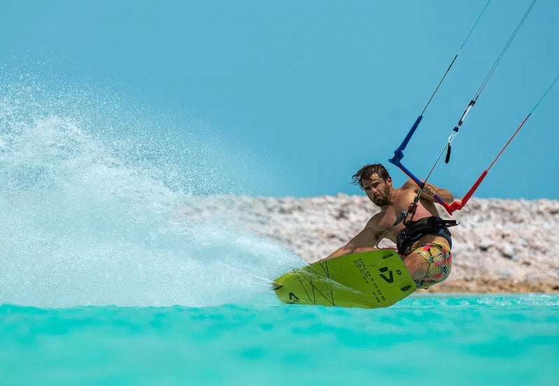 Load image into Gallery viewer, Green Hat Kiteboarding-Duotone Team Series SLS-Action Shot-Reno Romeu Carving in Crystal Blue Water