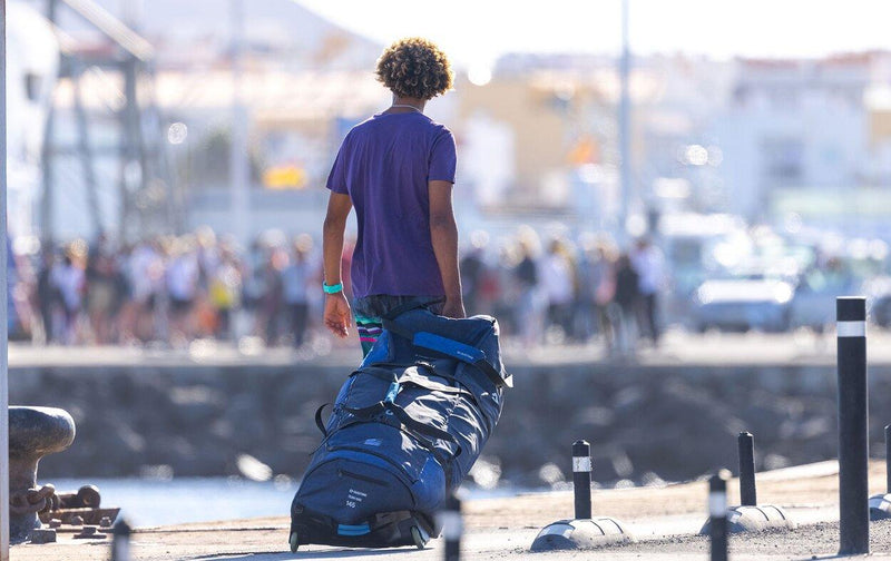 Load image into Gallery viewer, Green Hat Kiteboarding-Collection-Clearance Kite Bags-Duotone Combi Bag-Live Shot-Man Walking on Dock with Bag