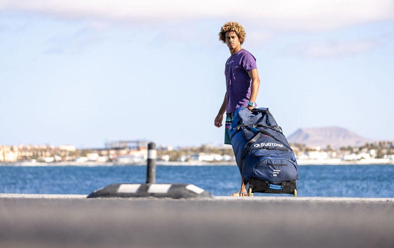 Load image into Gallery viewer, Green Hat Kiteboarding-Collection-Clearance Kite Bags-Duotone Combi Bag-Live Shot-Man Posing with Bag