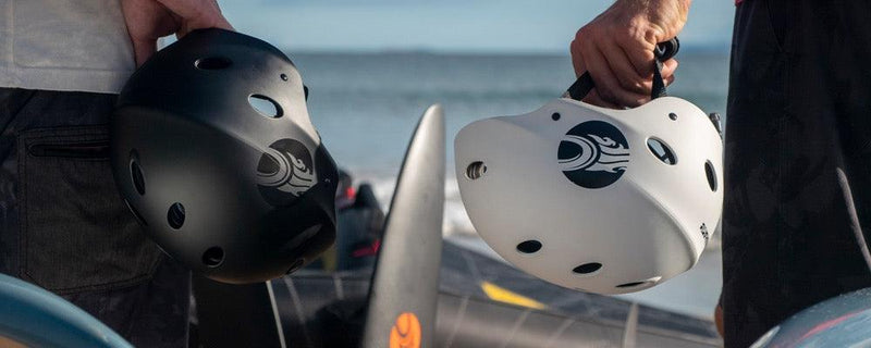 Load image into Gallery viewer, Cabrinha Water Helmet-Live Shot-2 Men Holding a Cabrinha Helmet each, One Black and 1 White
