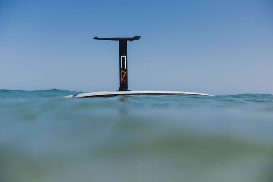 Code Foils hydrofoil showing its front wing, mast, and stabilizer above the water