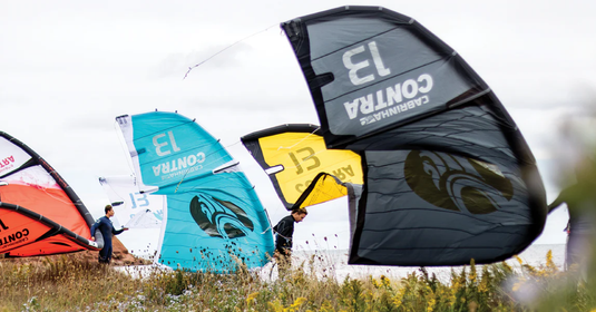 Green Hat Kiteboarding-three Contra Cabrinha kites-kiteboarding--one is black and yellow-the second is turquoise and white-the third is red and white