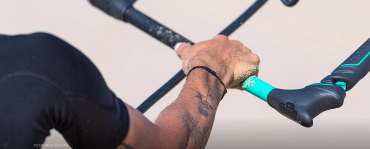 Green Hat Kiteboarding-Used Kite Control Bar Collection-North Navigator Bar Held in a Mans Hands