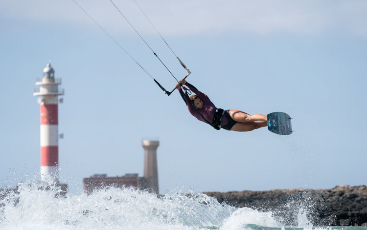 Green Hat Kiteboarding-Spring Suit/Shorty Collection-Ion Amaze Shorty Worn by Professional Kiter Paula N. Flying in the Sky