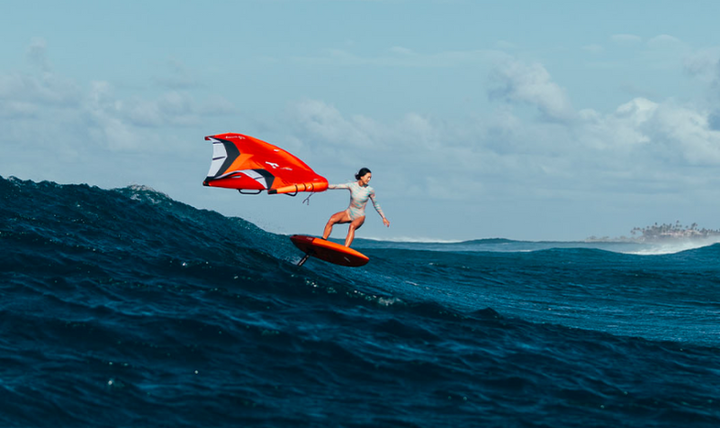 Load image into Gallery viewer, Green Hat Kiteboarding-2025 F-One Swing Wing-Flame/Onyx-Action Shot-Woman Riding Swell on her Swing Wing

