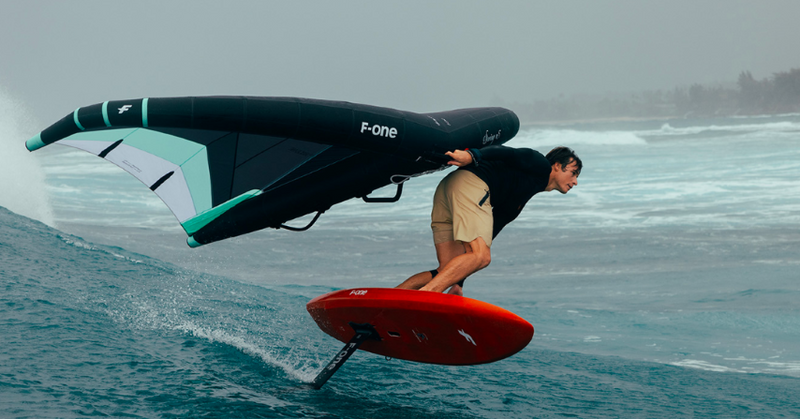 Load image into Gallery viewer, Green Hat Kiteboarding-2025 F-One Swing Wing-Flame/Onyx-Action Shot-Man Riding Swell on his Swing Wing
