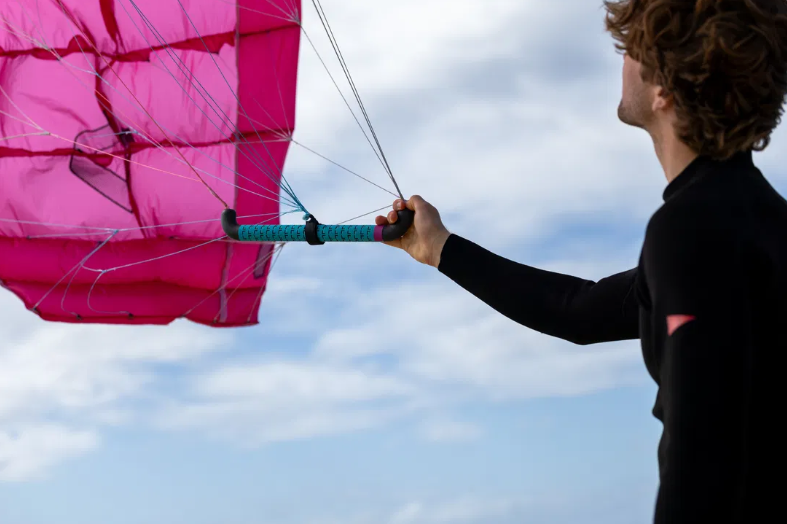 Load image into Gallery viewer, Green Hat Kiteboarding-Duotone Stash Parawing-Live Shot-Man Holding Stash Bar
