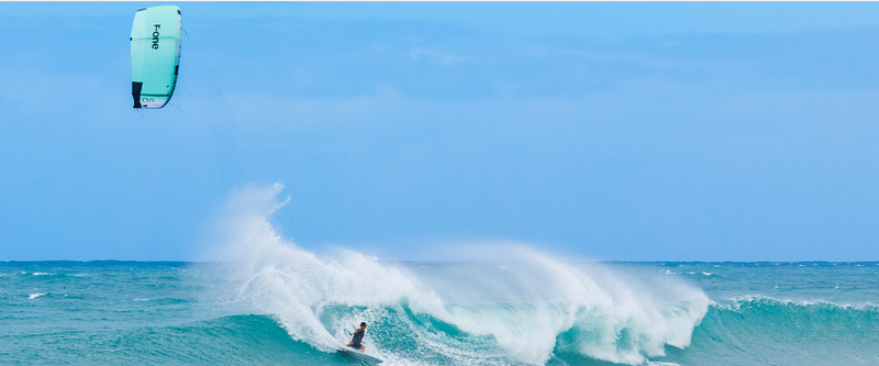 Load image into Gallery viewer, Green Hat Kiteboarding-2025_F-One_Addikt_Kite-Black/Mint-Pro Rider Keahi Surfing a Wave in Hawaii on the F-One Addikt  Wave Kite
