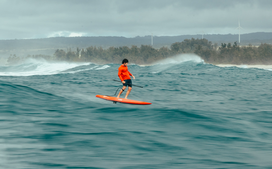 Green Hat Kiteboarding-2025 F-One Momentum Foil Plane-Action Shot-Man Downwinding Swell