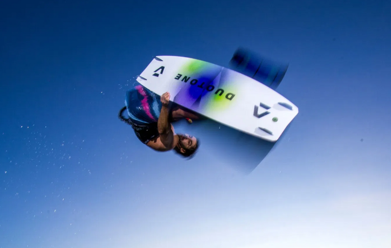 Load image into Gallery viewer, Green Hat Kiteboarding-2026 Duotone Select SLS Twintip-Action Shot-Man in the Air Kiteboarding on a Select SLS kiteboard 
