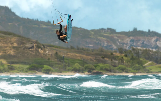 Green Hat Kiteboarding-2026 Duotone Traction Pad d/Lab Front-Action Shot-Man In Air While Kitesurfing