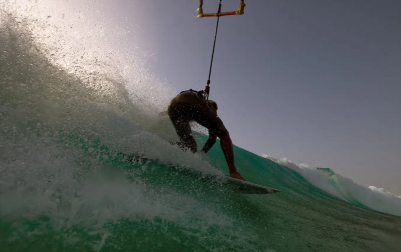 Load image into Gallery viewer, Green Hat Kiteboarding-2026 Duotone Volt SLS-Action Shot-Man Surfing a Wave on a Volt SLS Kitesurf Board
