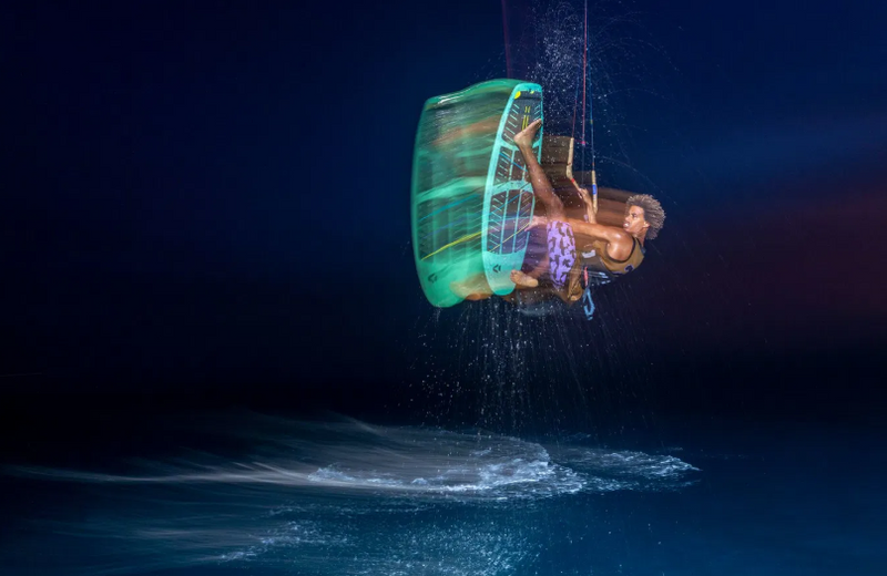 Load image into Gallery viewer, Green Hat Kiteboarding-2026 Duotone SLS Surfboard-Action Shot-Man Kiteboarding in the Air Riding a Whip SLS Surfboard
