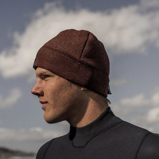 Person wearing an Ion Beanie against a cloudy sky