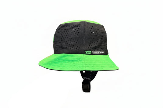 Black and green helmet with a visible brand logo on a wooden surface.